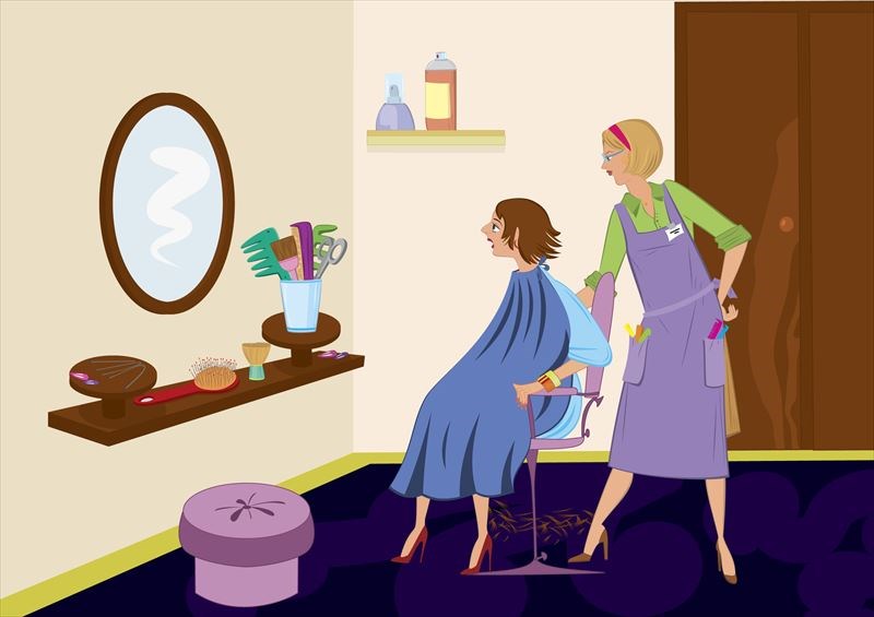 ヘアサロンのカットの後で鏡を見る女性と美容師