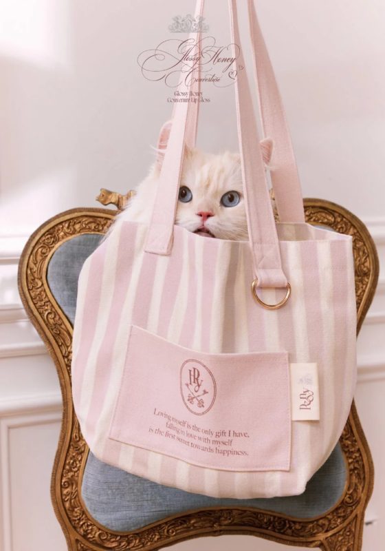 ピンクと白のストライプ柄トートバッグから顔を出す白い猫