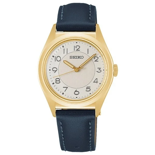 ゴールドケースと白い文字盤、ダークブルーの革ベルトが特徴のセイコー製アナログ腕時計