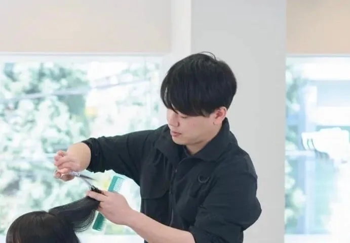 美容師がお客様の髪をカットする様子