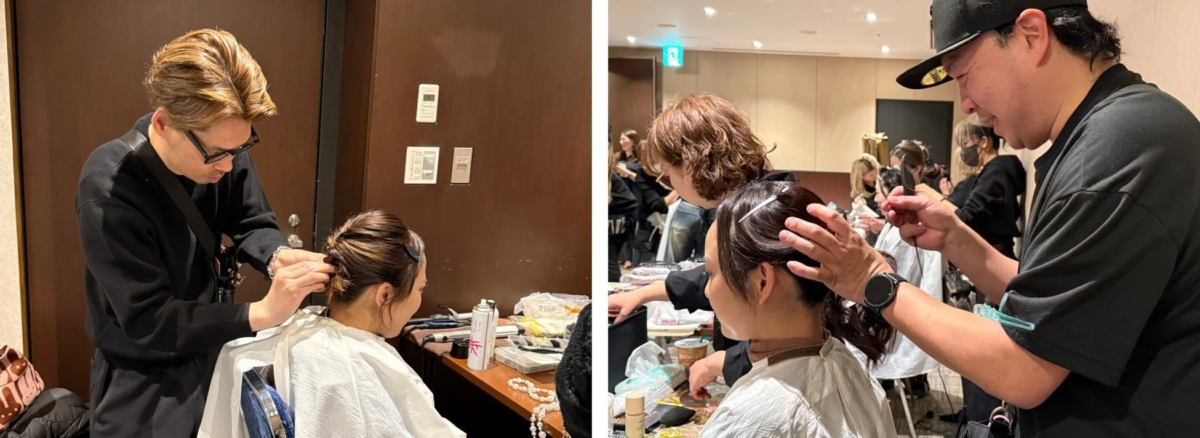 複数の美容師が女性のヘアセットを行っている様子。テーブルにはヘアスプレーなどの美容製品が置かれ、イベント前の準備風景をうかがわせます。