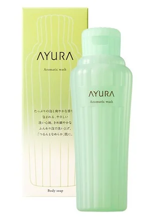 The bottle and package of AYURA Aromatic wash body soap. It is described as washing skin smooth with plenty of foam and a refreshing scent. The design is a clean green.