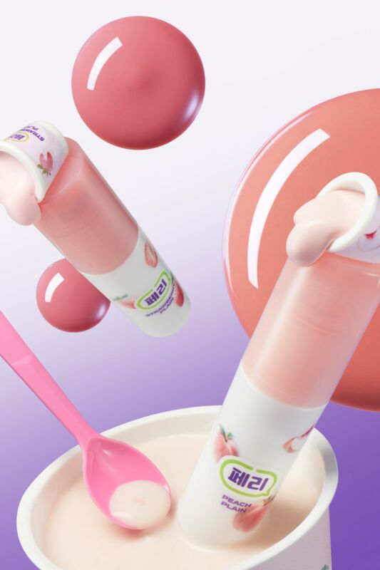 The peripera Ink Glasting Lip Gloss placed on a yogurt cup and spoon