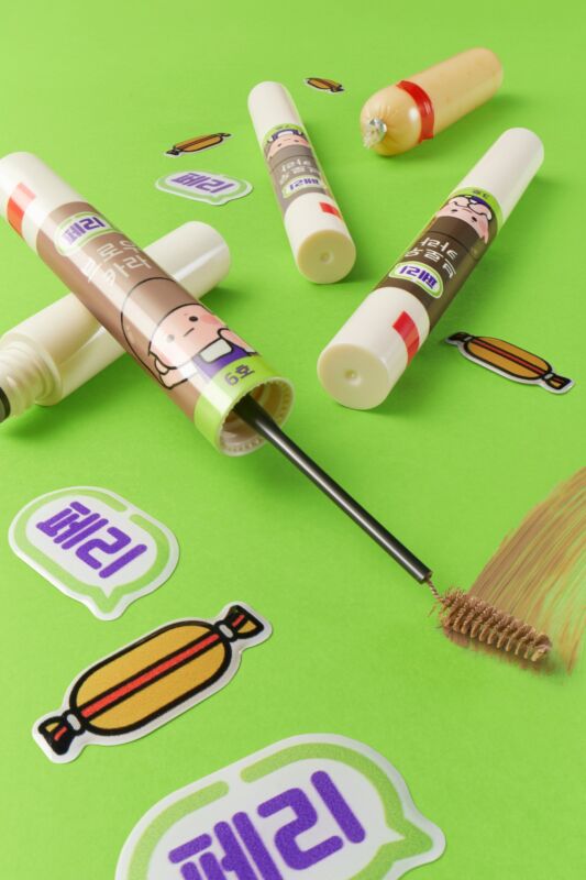 The peripera Speedy Skinny Brow Mascara in packaging with character illustrations