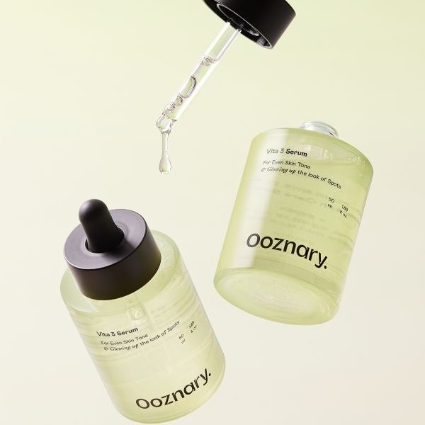 Two bottles of Vita3 Serum with a drop falling from the dropper