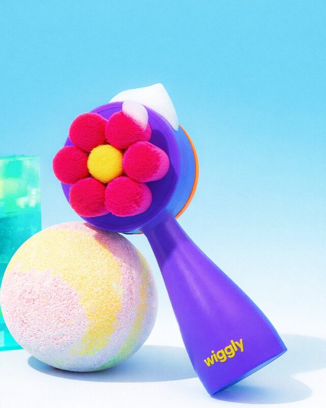 Dual Cleansing Brush - Purple with a purple handle and a red flower-shaped brush