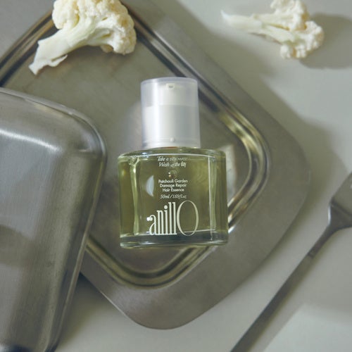 Patchouli Garden Damage Hair Essence in a clear bottle with a white pump