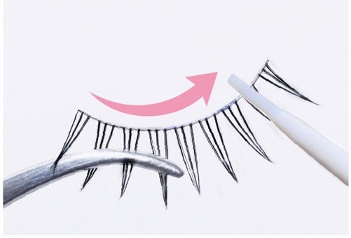 Applying adhesive to the base of a false eyelash