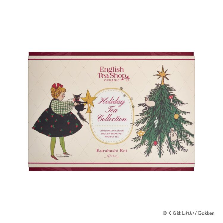 Package of the ENGLISH TEA SHOP Holiday Tea Collection, illustrated with a girl and a black cat decorating a Christmas tree with a star