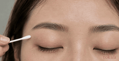 깨끗한 면봉을 눈썹 바깥쪽의 좁은 범위에 대는 동작